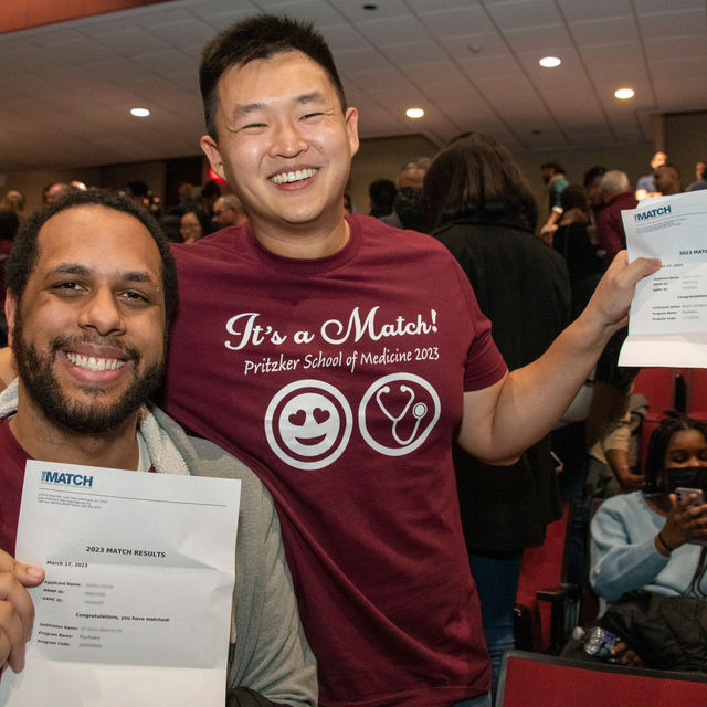 Two Pritzker Medical Students at Match Day holding Match Letters