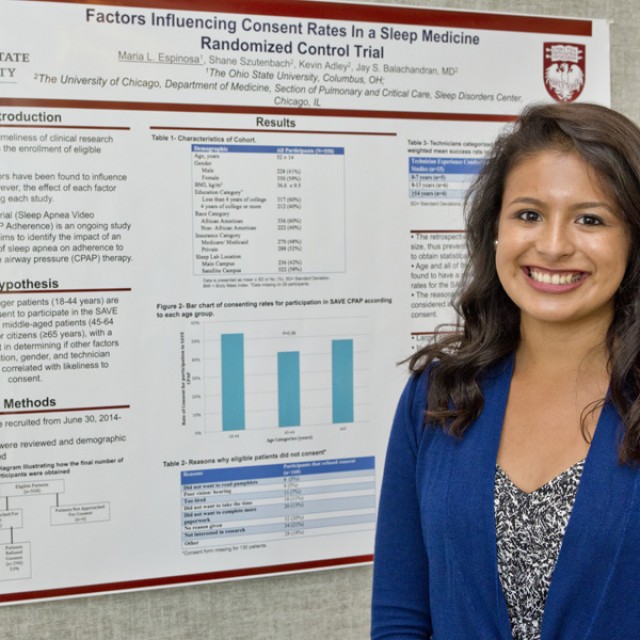 Photo of a student in front of a research poster