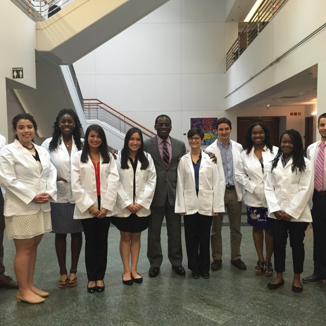 Photo of visiting students in white coats at Pritzker School of Medicine