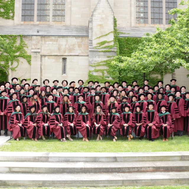 Photo of a graduating class of Pritzker students in regalia